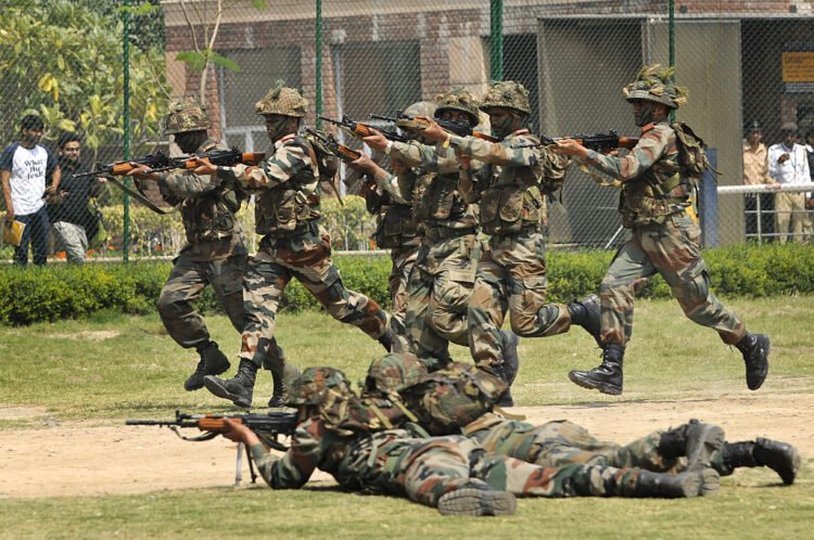 NOIDA, INDIA - MARCH 25:  Indian Army soldiers demonstrate their skills during mock drill and battle field conditions in front of the students on the second consecutive day, at Amity University, on March 25, 2015 in Noida, India. Army exhibited military weapon and equipments with an aim to motivate more youths to join defence services. During the event, soldiers demonstrated the diverse array of equipment, mock drill and stimulated battle field conditions. (Photo by Burhaan Kinu/Hindustan Times via Getty Images)